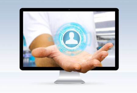 Businessman going out of a computer screen using social networkの写真素材