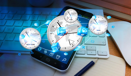Clocks connected to each other and flying over modern mobile phone in office