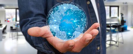 Businessman holding digital web earth with connection linesの写真素材