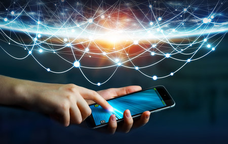 Businesswoman using digital tactile phone to send information to the world