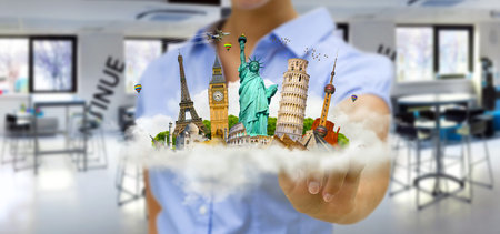 Young woman holding a cloud full of famous monuments of the world in his hands