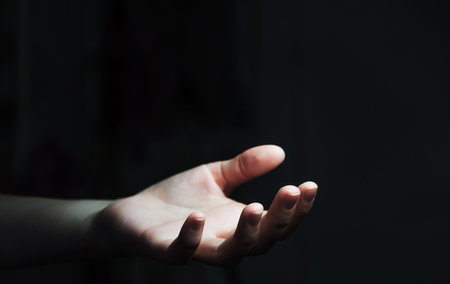Empty businesswoman hand on black dark background officeの写真素材