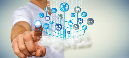 Businessman holding circuit over a cloud with modern application icon