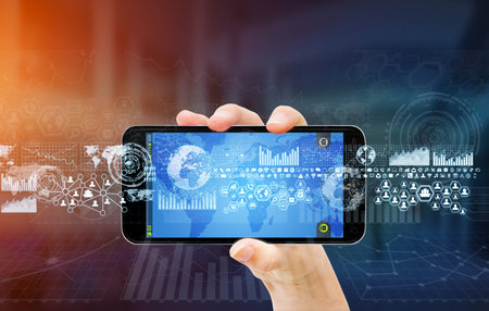 Businesswoman using digital tactile charts screen with his mobile phone