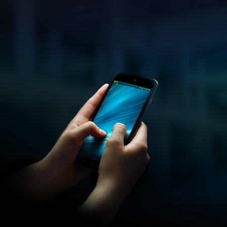 Businesswoman using modern mobile phone in office