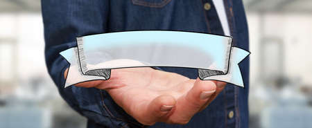 Businessman holding hand drawn banner ribbon in his handの写真素材