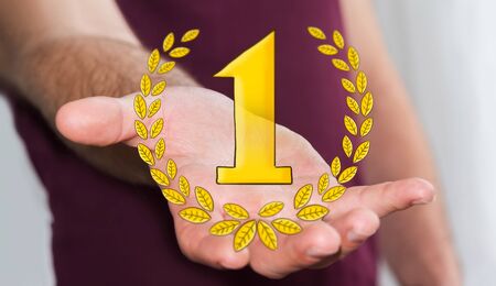 Businessman holding hand drawn winner trophy icons in his handの写真素材