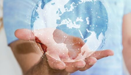 Businessman in office using digital tactile world interface with his handの写真素材