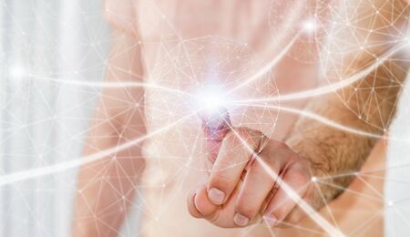 Businessman in office touching digital data network with his fingerの写真素材