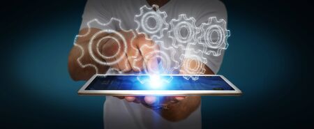 Businessman with 3D engine plan over his mobile phoneの写真素材