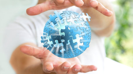Businessman holding flying puzzle sphere in his hand ‘3D rendering’