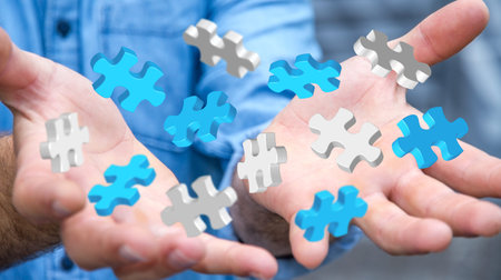 Businessman holding flying puzzle pieces in his hand ‘3D rendering’