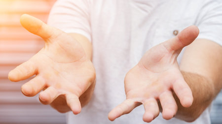 Empty businessman hand on bright blurred background