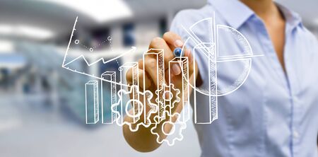 Businesswoman drawing chart and graphic with a penの写真素材