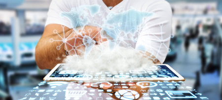 World over a cloud with connections and modern icons in businessman hand