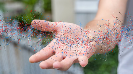 Man on blurred background holding DNA structure in his handの写真素材