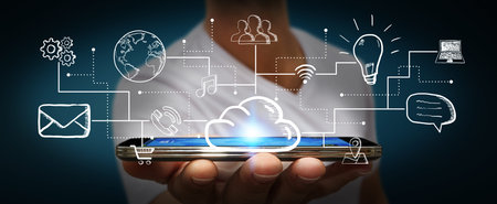 Businessman connecting multimedia icons together with his mobile phone