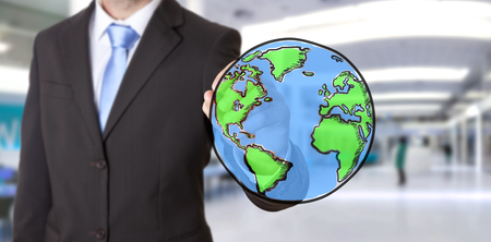 Businessman drawing planet earth wih a penの写真素材