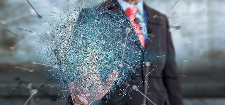 Businessman on blurred background touching 3D rendering data network sphere with his fingersの写真素材