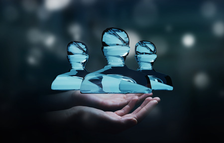 Businessman on blurred background holding shiny glass avatar group 3D renderingの写真素材