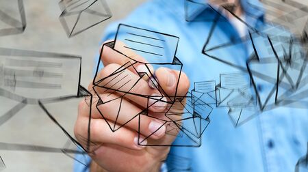 Businessman on blurred drawing manuscript contact icon with a penの写真素材