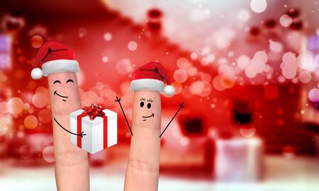 Happy finger family celebrating christmas on red backgroundの写真素材