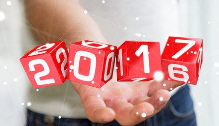 Businessman holding 2017 3D rendering text in dices in his hand