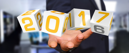 Businessman holding 2017 3D rendering text in dices in his handの写真素材