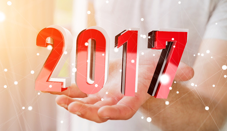 Businessman holding colorful 2017 3D rendering text in his handの写真素材