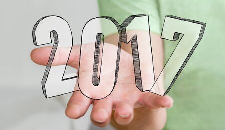 Businessman touching 2017 hand drawn text with his fingerの写真素材