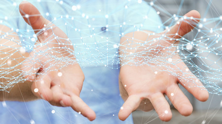 Businessman on blurred background holding flying network dot 3D renderingの写真素材