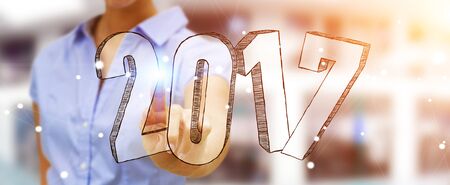 Businesswoman touching 2017 hand drawn text with her fingerの写真素材