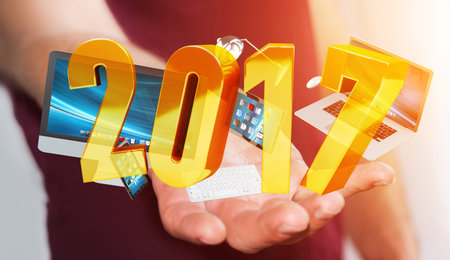 Businessman holding 2017 3D rendering text with tech device in his hand