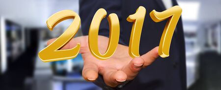 Businessman holding colorful 2017 3D rendering text in his handの写真素材