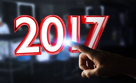 Businessman touching colorful 2017 3D rendering text with his fingerの写真素材