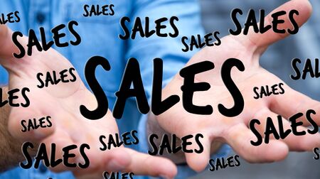 Businessman on blurred background holding sales icons in his hand 3D renderingの写真素材