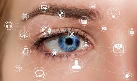 Close-up of woman eye using multimedia network with modern icons 3D renderingの写真素材