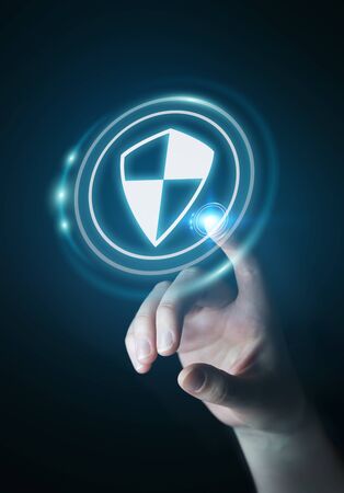 Businesswoman on blurred background using shield safe protection to protect her datas 3D renderingの写真素材