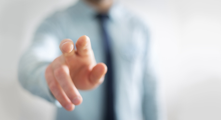 Businessman on blurred background pointing his fingerの写真素材