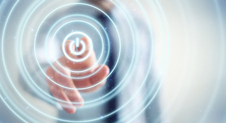 Businessman on blurred background pushing 3D render power button with his finger
