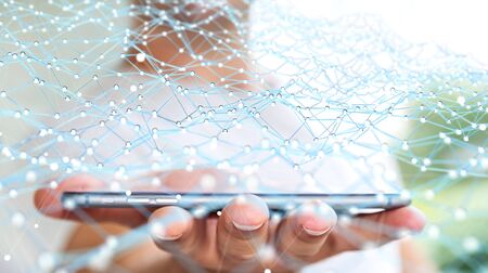 Businessman on blurred background holding flying network over phone 3D renderingの写真素材