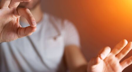 Businessman on blurred background showing his empty handの写真素材