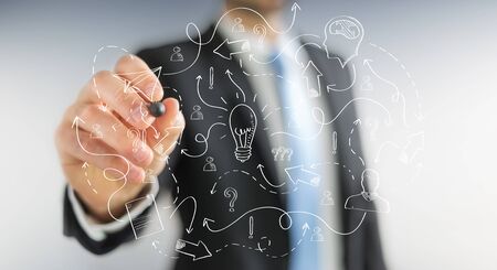 Businessman on blurred background drawing manuscript project presentation with a penの写真素材