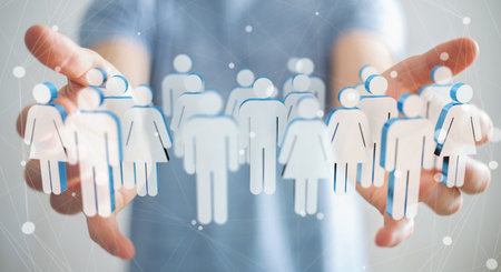 Businessman on blurred background holding 3D rendering group of people in his hand