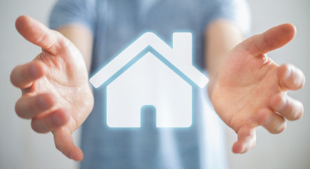 Businessman on blurred background holding 3D rendering icon house in his hand