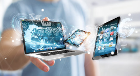 Businessman on blurred background connecting tech devices 3D rendering