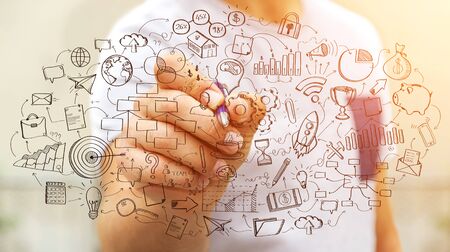 Businessman on blurred background drawing manuscript project presentation with a penの写真素材