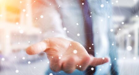 Businessman on blurred background holding floating dot network 3D renderingの写真素材