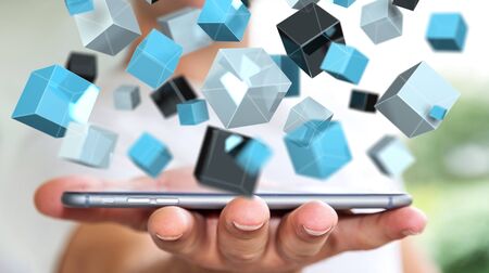 Businessman on blurred background holding floating blue shiny cube network 3D renderingの写真素材