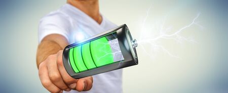 Man on blurred background touching 3D render battery with lightning with his fingerの写真素材
